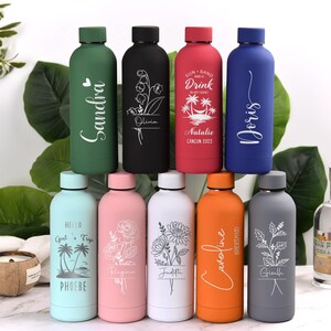 May include: A collection of ten insulated water bottles in various colors, each with a unique design. The bottles feature names, floral patterns, and tropical graphics. The bottles are approximately 10 inches tall.