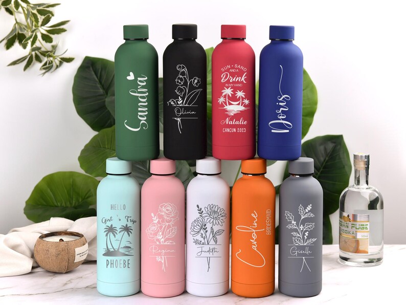 May include: A collection of ten insulated water bottles in various colors, each with a unique design. The bottles feature names, floral patterns, and tropical graphics. The bottles are approximately 10 inches tall.