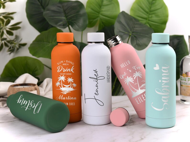 May include: A collection of insulated water bottles in various colors, including orange, white, pink, green, and light blue. Each bottle features personalized text and tropical-themed designs, ideal for a beach vacation or bridal party.