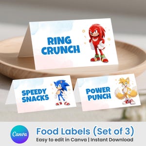 May include: Three white folded paper food labels featuring blue text and cartoon characters. One label reads RING CRUNCH with a red character, one reads SPEEDY SNACKS with a blue character, and one reads POWER PUNCH with a yellow character.