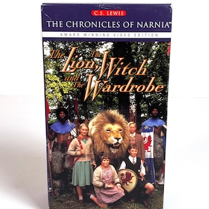May include: A VHS tape of "The Chronicles of Narnia: The Lion, the Witch, and the Wardrobe." The cover features a group of children with a lion, and the title text in gold. The top of the box reads "C.S. Lewis" and "Award Winning Video Edition."