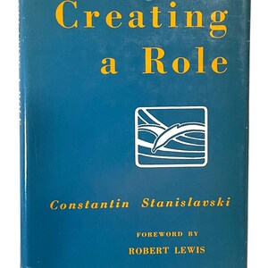 May include: A book titled "Creating a Role" by Constantin Stanislavski. The cover is a deep teal color with gold lettering. The title is in large, bold letters. A white and black graphic is in the center. The foreword is by Robert Lewis.