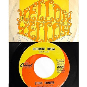 May include: A vintage vinyl record and sleeve. The sleeve is yellow with orange lettering that reads "Yellow Zeppelin." The record label is orange and yellow, with the text "Different Drum" and "Stone Poneys" featuring Linda Ronstadt.