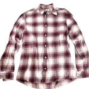 May include: A long-sleeved button-down shirt with a plaid pattern in burgundy and white. The shirt has a classic collar and buttoned cuffs. The fabric appears to be a lightweight material, suitable for casual wear.