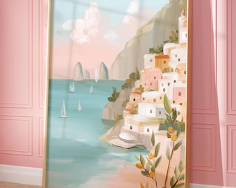 May include: A framed art print depicting a coastal village scene. The artwork features white buildings with orange roofs on a hillside, sailboats on the water, and a light blue sky. The frame is gold.