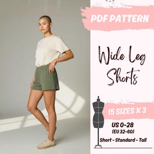 May include: A person wearing a cream-colored t-shirt and olive green shorts. The image includes text that reads "PDF PATTERN Wide Leg Shorts" and size information for US sizes 0-28. The pattern is available in A0/A4/US Letter formats.