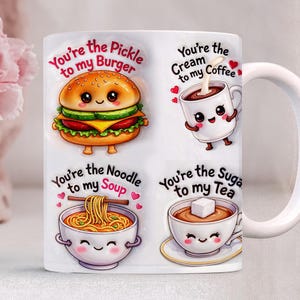 May include: White ceramic mug featuring four cute food-themed illustrations. The mug has the phrases "You're the Pickle to my Burger", "You're the Cream to my Coffee", "You're the Noodle to my Soup", and "You're the Sugar to my Tea".