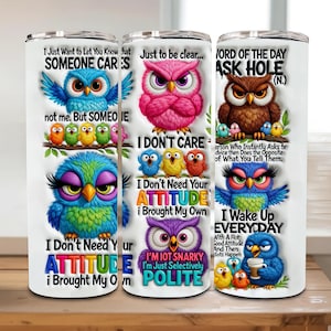 May include: Three white insulated tumblers with colorful cartoon owl designs and humorous text. The owls are in various colors, including blue, pink, and purple. Text includes phrases like "I don't care" and "I wake up everyday."