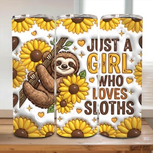 May include: A white tumbler featuring a brown sloth hanging from a branch, surrounded by yellow sunflowers. The tumbler has the text "JUST A GIRL WHO LOVES SLOTHS" in brown and yellow. The design includes hearts and stars.