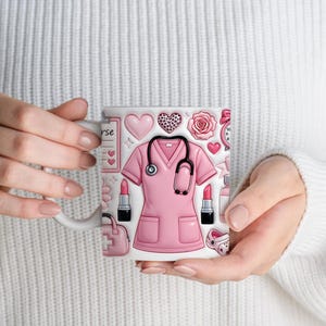 May include: White ceramic mug featuring a pink nurse's uniform, stethoscope, hearts, lipstick, and other medical-themed illustrations. The mug has a white handle and is held by a person wearing a white sweater.