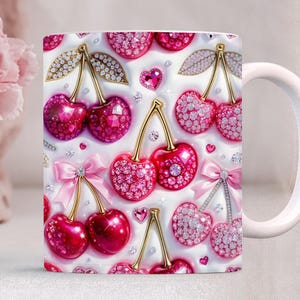 May include: White ceramic mug featuring a repeating pattern of cherries with gold stems, sparkling pink gems, and pink bows. The cherries have a mix of glossy and gem-studded surfaces, creating a glamorous aesthetic.