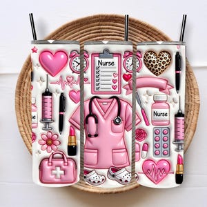 May include: Three white stainless steel tumblers with black straws, decorated with pink nurse-themed graphics. Designs include hearts, stethoscopes, syringes, and the word "Nurse". The tumblers sit on a woven tray.