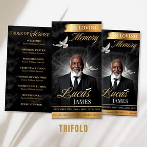 May include: A black and gold trifold memorial card with the text "In Loving Memory" and a portrait of a man. The card includes the name "Lucas James" and dates, with a dove graphic. The left panel lists an order of service.