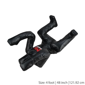 May include: Black freestanding training dummy with a red "MMA Street" logo. The dummy is in a fighting pose with arms and legs bent. It is 4 feet tall, 48 inches, or 121.92 cm.