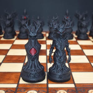May include: A black chess set with intricately designed pieces. The pieces feature a dark, gothic aesthetic with antler-like structures and red accents. The chess board is made of wood with a checkered pattern.