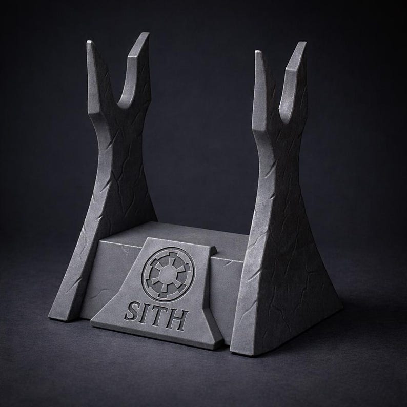 May include: A dark gray lightsaber display stand with a textured surface. The stand features two upright supports and a base with the word "SITH" and a circular emblem. The overall design is reminiscent of a sci-fi theme.