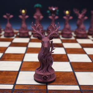 May include: A burgundy chess set with a deer-shaped king piece. The chess pieces are arranged on a wooden chessboard with light and dark squares. Other pieces include a tower, a bishop, and a queen.