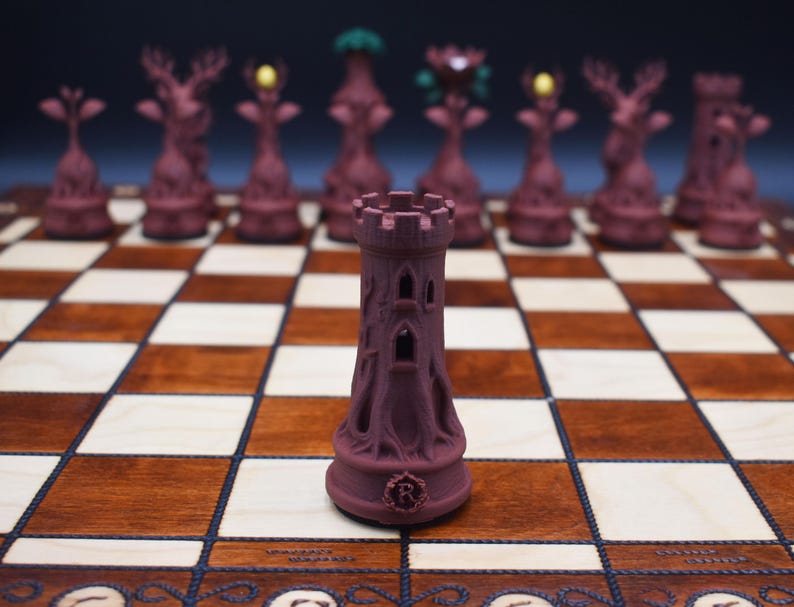 May include: A close-up of a burgundy chess set on a wooden chessboard. The focus is on a castle piece with a detailed, textured design. Other pieces, including deer and tree-shaped figures, are visible in the background. The board has light and dark squares.