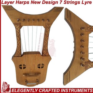 May include: A wooden 7-string lyre with a new design. The instrument has a light brown finish, with decorative carvings and a series of tuning pegs. The text "Layer Harps New Design 7 Strings Lyre" is visible at the top.