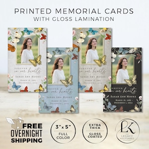 May include: Printed memorial cards with gloss lamination. Each card features a photo of a woman, framed with butterflies and flowers. The text reads "Forever in our hearts" and includes a name and dates. The cards are 3" x 5" and full color.