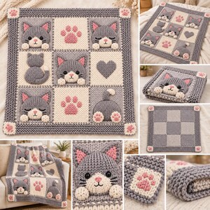 May include: A square knitted blanket featuring a grid pattern of grey and cream squares. The design includes three-dimensional grey cat faces, pink paw prints, and a grey heart. The border is a thick grey knit with small pink paw accents.