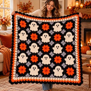 May include: A square crochet blanket featuring a repeating pattern of white ghost motifs and orange flower motifs on a black background. The blanket is bordered by a scalloped edge in alternating rows of white, orange, and black yarn.