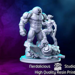 May include: A gray resin statue featuring two comic book characters, Juggernaut and Wolverine, in a dynamic pose. Wolverine stands on a mechanical structure, facing Juggernaut. The base is detailed with mechanical elements. The text "Nerdalicious Studios High Quality Resin Prints" is at the bottom.