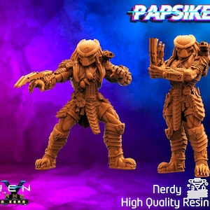 May include: Two detailed, tan-colored Predator figurines in dynamic poses. One figure is posed with an open hand, the other holding a weapon. The background is a gradient of purple and blue with the text "Papsikels" and "Alien vs Ground Zero". The figurines are labeled "Nerdy Minis High Quality Resin Prints".