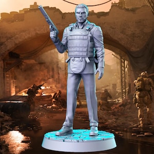 May include: A gray plastic figurine of a person wearing a tactical vest and holding a gun. The figurine is standing on a round base with a blue and gray design. The background is a blurry image of a war-torn city.