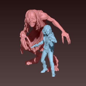 May include: A 3D-printed figurine set featuring a light blue figure holding a gun, facing a large, pink, monstrous figure with a wide grin and long fingers. The figures are set against a dark brown background.