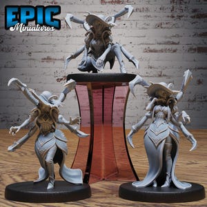 May include: Three gray miniature figures of a fantasy character with multiple arms and a hat. The figures are on black bases, with one figure on a red and clear stand. The text "EPIC Miniatures" is in the upper left corner.