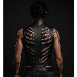 May include: A black leather vest featuring a series of horizontal cutouts across the back panel that resemble a rib cage structure. The garment has a high collar and a fitted silhouette, showcasing a smooth texture and clean, stitched seams.