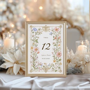 Elegant floral wedding invitation suite featuring pastel wildflowers and gold frame accents. Includes RSVP card, details card, welcome sign, thank you card, menu card, table number and main invitation with botanical illustrations on a soft ivory background. Romantic and vintage-inspired design, perfect for spring or boho weddings.