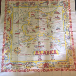 May include: A vintage map of Alaska with a yellow background and red, blue, and green details. The map shows the state's major cities, rivers, and mountains. The text "ALASKA" is written in large, red letters across the center of the map. The text "586,400 SQUARE MILES" is written in black letters below the map. The text "PRICE $7,200,000 (MAR 1927)" is written in black letters below the text "586,400 SQUARE MILES".