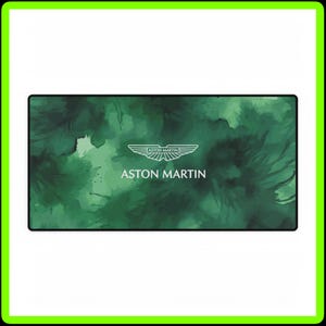 May include: A green watercolor background with white splotches. The Aston Martin logo is in the center with the text "ASTON MARTIN" below it.