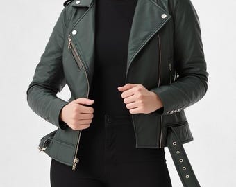 May include: A dark forest green motorcycle jacket featuring a notched lapel, silver-toned metal zippers, and snap button accents. The jacket includes a waist belt with a buckle, zippered pockets, and long sleeves with zippered cuffs, worn over a black top.