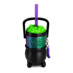 May include: A black cauldron-shaped tumbler with a handle, featuring a green bubbly top and a purple glittery straw. A metallic band around the center displays the text Witches Brew in raised lettering, accompanied by a small purple charm on a chain.