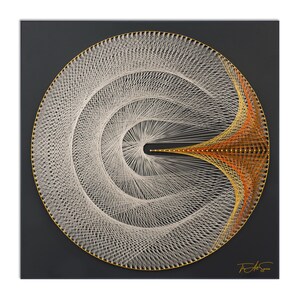 May include: A circular string art piece with a white and gold design on a dark gray background. The design features a series of concentric circles with a single, curved line extending from the center.