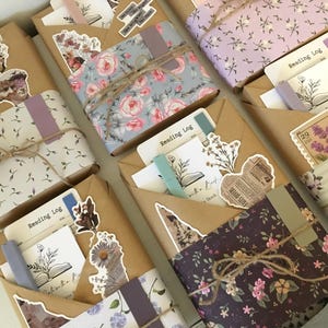 May include: Six wrapped gifts with a floral theme. Each gift is wrapped in brown paper with a floral pattern and tied with twine. The gifts are decorated with stickers and other embellishments. The gifts are all labeled "Reading Log".