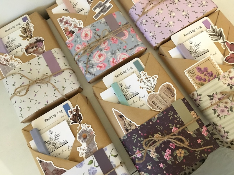 May include: Six wrapped gifts with a floral theme. Each gift is wrapped in brown paper with a floral pattern and tied with twine. The gifts are decorated with stickers and other embellishments. The gifts are all labeled "Reading Log".