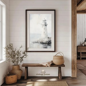 A grouped display of coastal printable wall art with several framed seaside images, including a lighthouse on rocky shore, a sailboat on still water, a sunset harbor scene, a coastal village by the sea, and a text-based nautical design reading Salt Air Adventure. The artwork uses gentle blue, cream, and soft golden tones with watercolor-style detail, creating a classic coastal grandmother mood with elegant nautical imagery and a calm, collected printable bundle look.