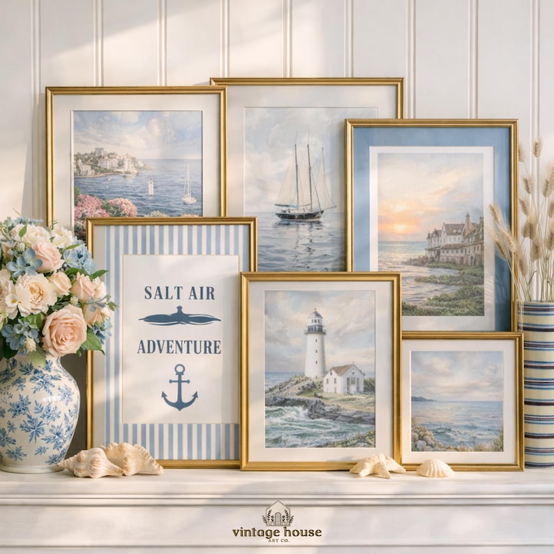 A grouped display of coastal printable wall art with several framed seaside images, including a lighthouse on rocky shore, a sailboat on still water, a sunset harbor scene, a coastal village by the sea, and a text-based nautical design reading Salt Air Adventure. The artwork uses gentle blue, cream, and soft golden tones with watercolor-style detail, creating a classic coastal grandmother mood with elegant nautical imagery and a calm, collected printable bundle look.