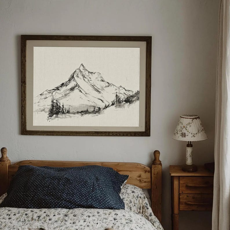 A timeless digital mountain sketch print designed for elegant, nature-inspired interiors. This printable wall art brings a calm, vintage feel to living rooms, bedrooms, offices, and cabin spaces.Vintage printable mountain wall art shown in a dark wood frame, featuring a black and white landscape sketch on a neutral background.Vintage printable mountain wall art shown in a dark wood frame, featuring a black and white landscape sketch on a neutral background.