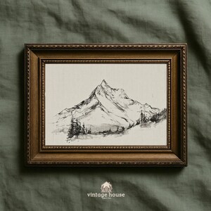 A timeless digital mountain sketch print designed for elegant, nature-inspired interiors. This printable wall art brings a calm, vintage feel to living rooms, bedrooms, offices, and cabin spaces.Vintage printable mountain wall art shown in a dark wood frame, featuring a black and white landscape sketch on a neutral background.Vintage printable mountain wall art shown in a dark wood frame, featuring a black and white landscape sketch on a neutral background.