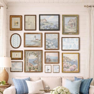 A grouped display of coastal printable wall art with several framed seaside images, including a lighthouse on rocky shore, a sailboat on still water, a sunset harbor scene, a coastal village by the sea, and a text-based nautical design reading Salt Air Adventure. The artwork uses gentle blue, cream, and soft golden tones with watercolor-style detail, creating a classic coastal grandmother mood with elegant nautical imagery and a calm, collected printable bundle look.
