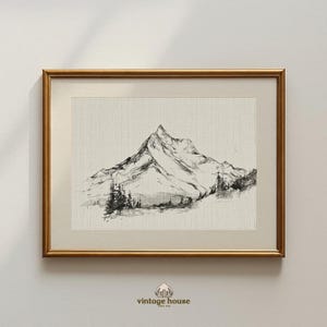 A timeless digital mountain sketch print designed for elegant, nature-inspired interiors. This printable wall art brings a calm, vintage feel to living rooms, bedrooms, offices, and cabin spaces.Vintage printable mountain wall art shown in a dark wood frame, featuring a black and white landscape sketch on a neutral background.Vintage printable mountain wall art shown in a dark wood frame, featuring a black and white landscape sketch on a neutral background.