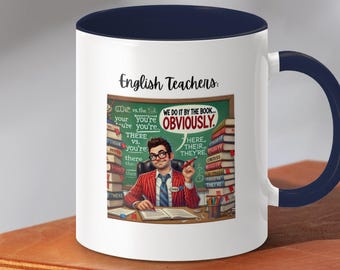 May include: White ceramic coffee mug with a blue rim and handle. The mug features a cartoon illustration of a teacher surrounded by books and a chalkboard with the text "We do it by the book... Obviously." and "English Teachers:"
