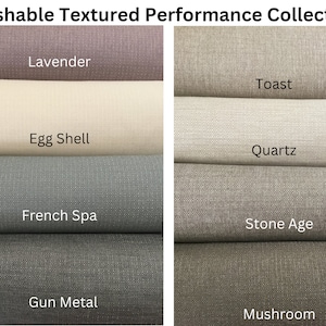 May include: A selection of fabric swatches with a textured finish, in a range of neutral tones. The swatches are labelled with names such as "Lavender", "Egg Shell", "French Spa", "Gun Metal", "Toast", "Quartz", "Stone Age", and "Mushroom". The image shows the "Washable Textured Performance Collection."