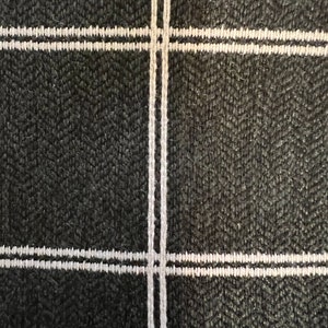 May include: Black fabric with a white double-lined grid pattern.