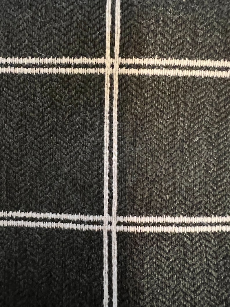 May include: Black fabric with a white double-lined grid pattern.